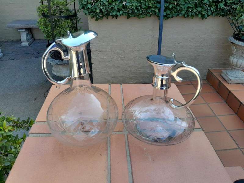 An Early 20th Century Set of Two Silver-Plated Crystal Claret Jugs