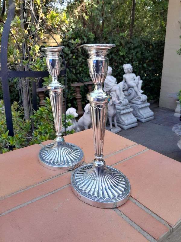 An Early 19th Century Pair of George III Old Sheffield Plated Candlesticks On Loaded Bases