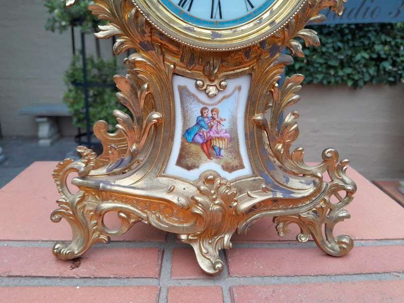 An Antique Century French Rococo Style Clock Garniture Set with Pair of Candelabras  with  Pend...