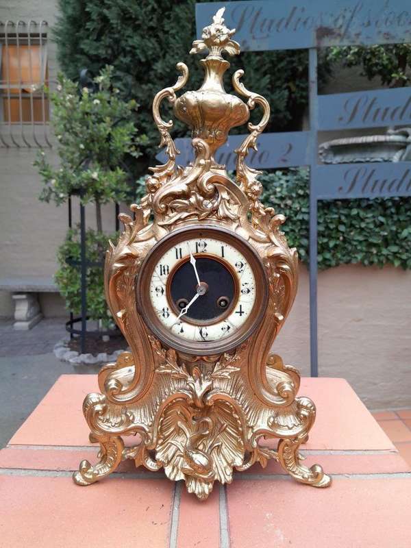 An Antique French Rococo Style Ormolu Clock with Key