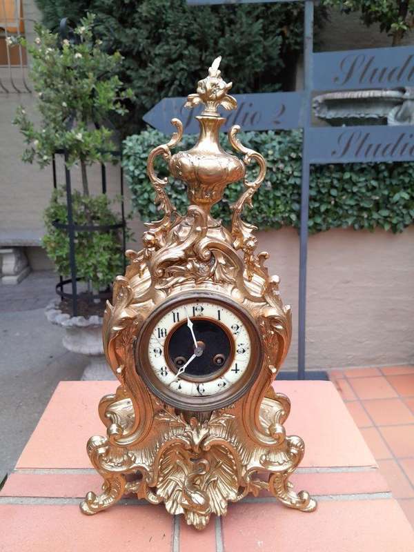 An Antique French Rococo Style Ormolu Clock with Key