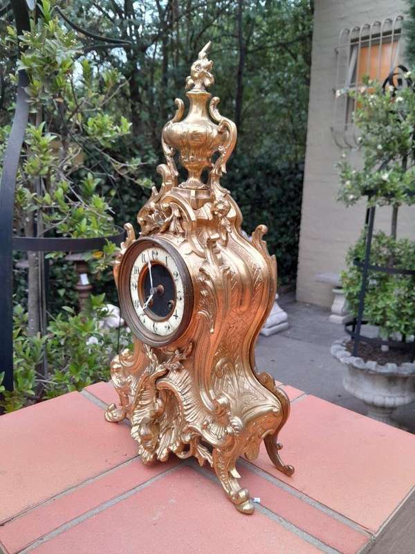 An Antique French Rococo Style Ormolu Clock with Key