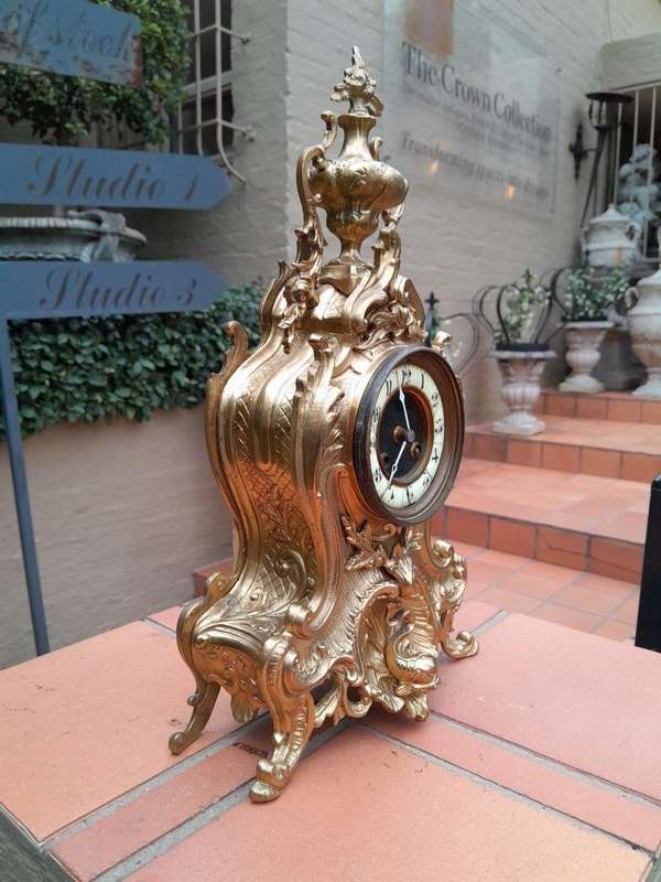 An Antique French Rococo Style Ormolu Clock with Key