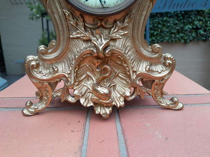 An Antique French Rococo Style Ormolu Clock with Key