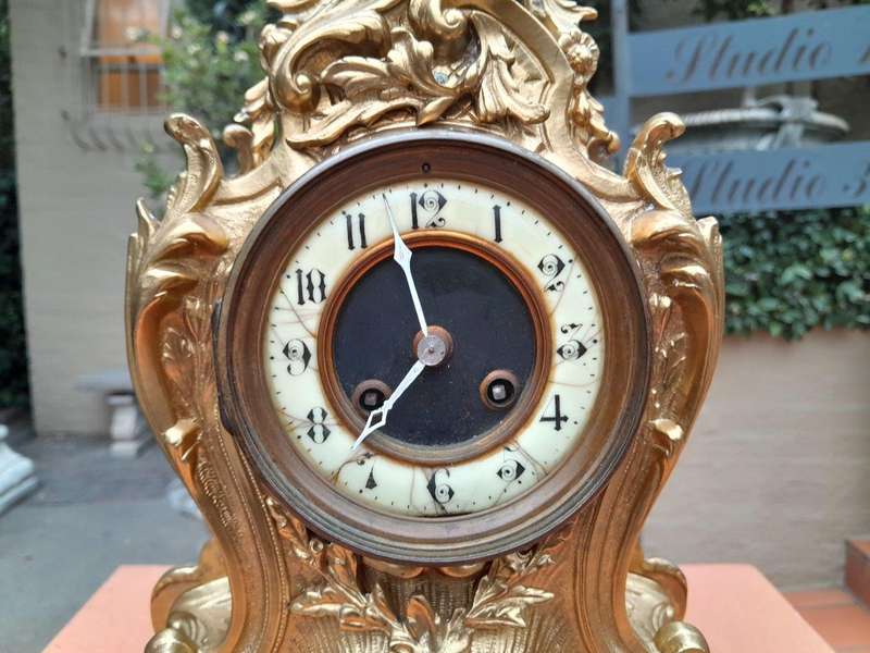 An Antique French Rococo Style Ormolu Clock with Key