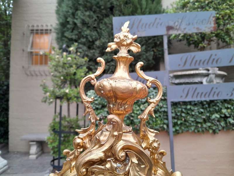 An Antique French Rococo Style Ormolu Clock with Key