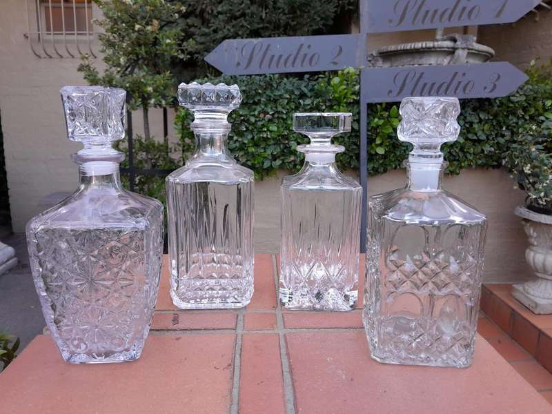 A Set Of Two Crystal Decanters And Two Cut Glass Decanters