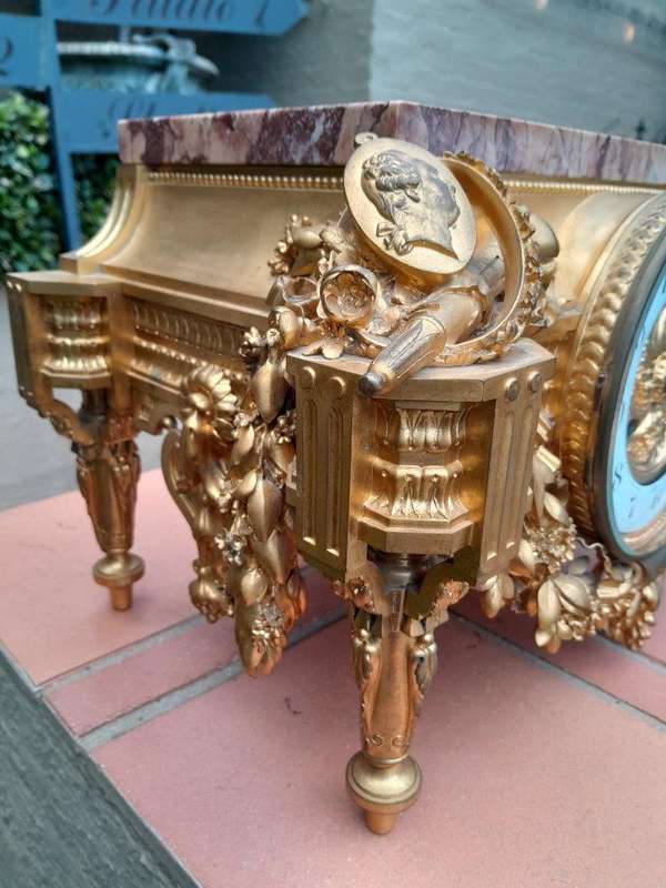 A 19th Century French Gilt Metal with Marble Top Clock