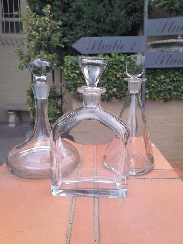 A Set of Three Glass Decanters