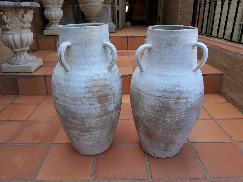 A Decorative Pair Of Cement Urns Of Large Proportion With Handles
