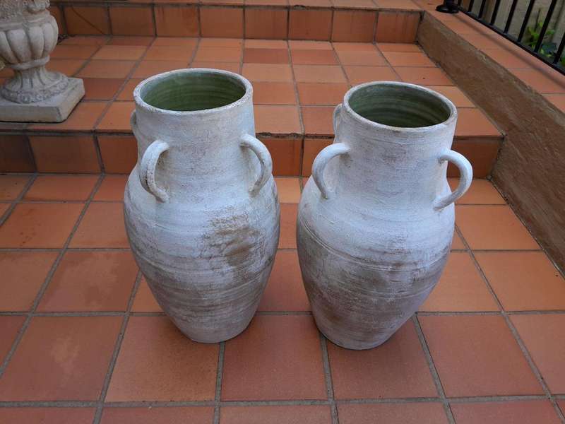 A Decorative Pair Of Cement Urns Of Large Proportion With Handles