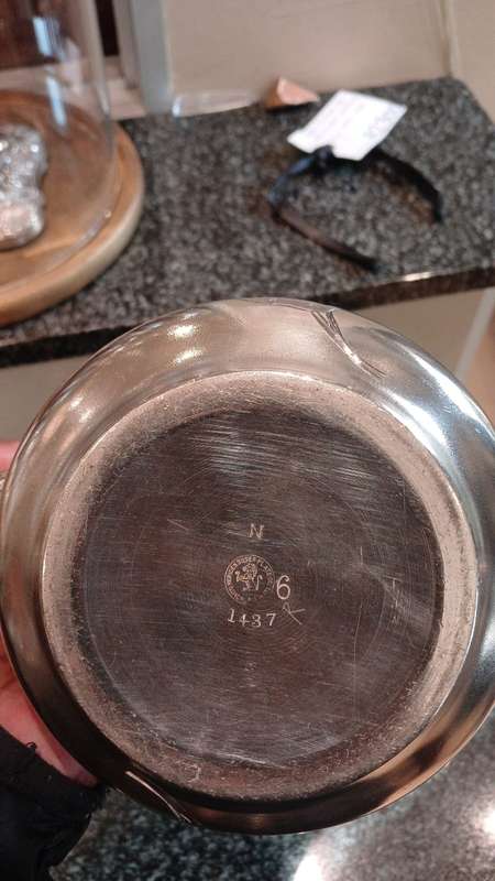 A Silver-Plated Tea Pot With Floral Designs