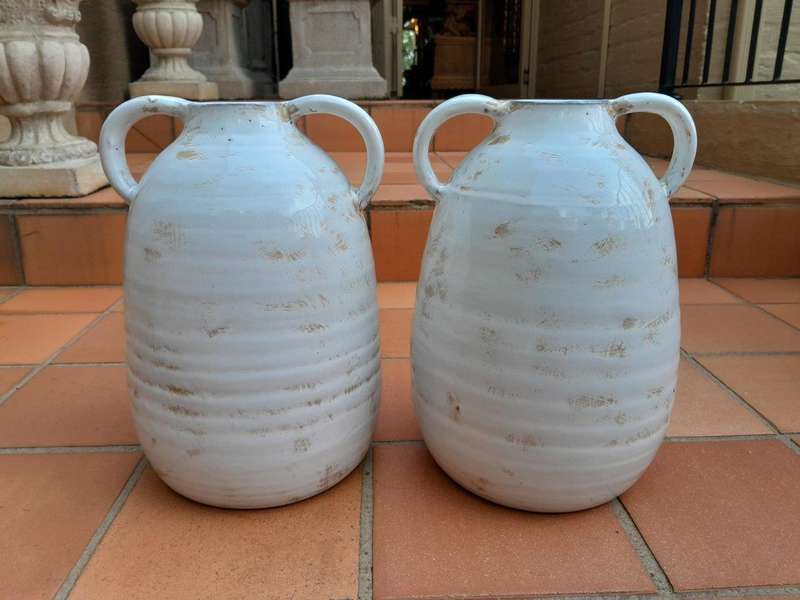 A Pair Of Ceramic Urns With Two Handles