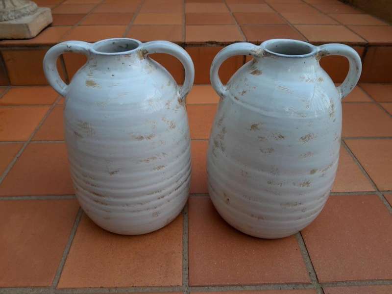 A Pair Of Ceramic Urns With Two Handles