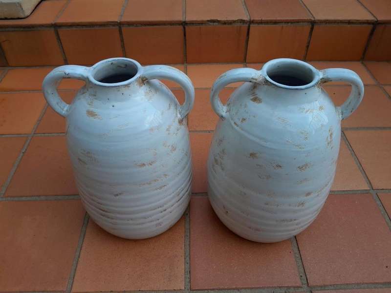 A Pair Of Ceramic Urns With Two Handles