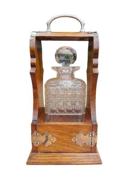 An Antique Victorian Tantalus With A Crystal Decanter And Key