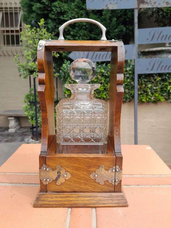 An Antique Victorian Tantalus With A Crystal Decanter And Key