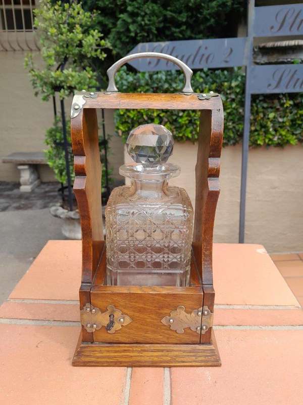 An Antique Victorian Tantalus With A Crystal Decanter And Key