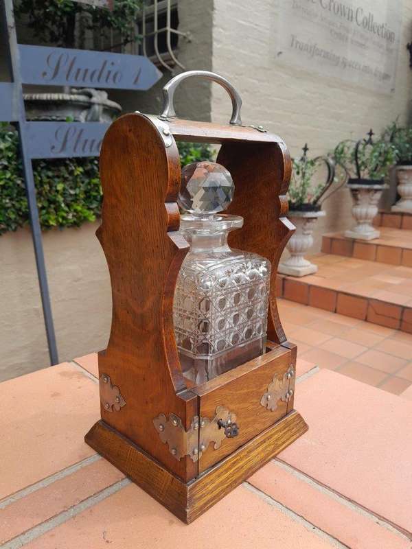 An Antique Victorian Tantalus With A Crystal Decanter And Key