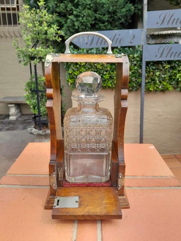 An Antique Victorian Tantalus With A Crystal Decanter And Key
