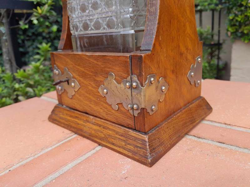 An Antique Victorian Tantalus With A Crystal Decanter And Key