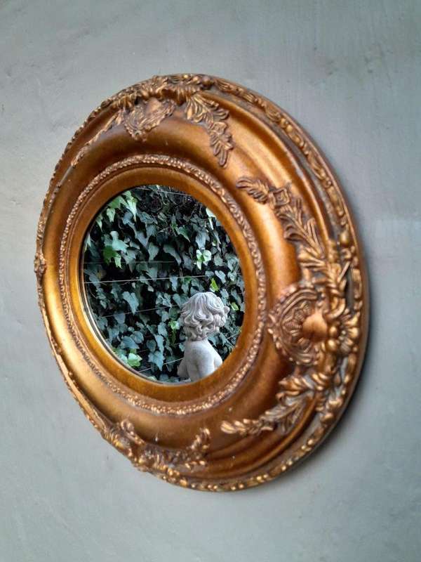 A French Style Carved Oval Giltwood Mirror