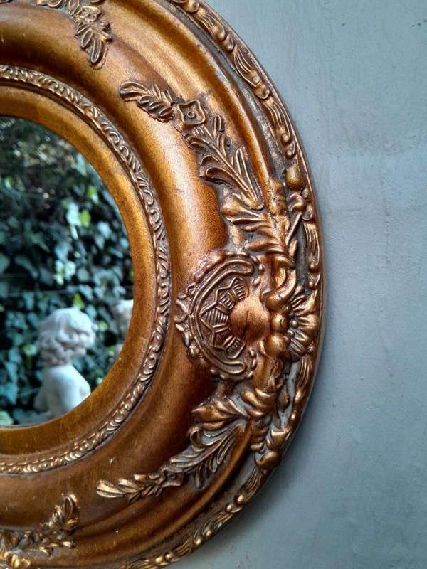 A French Style Carved Oval Giltwood Mirror