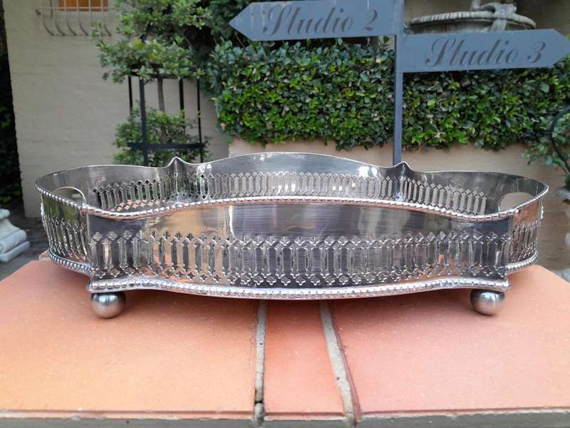 A Silver-Plate Gallery Tray On Bun Feet