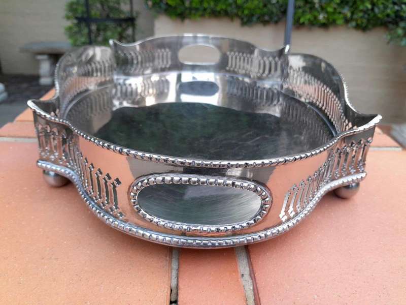 A Silver-Plate Gallery Tray On Bun Feet