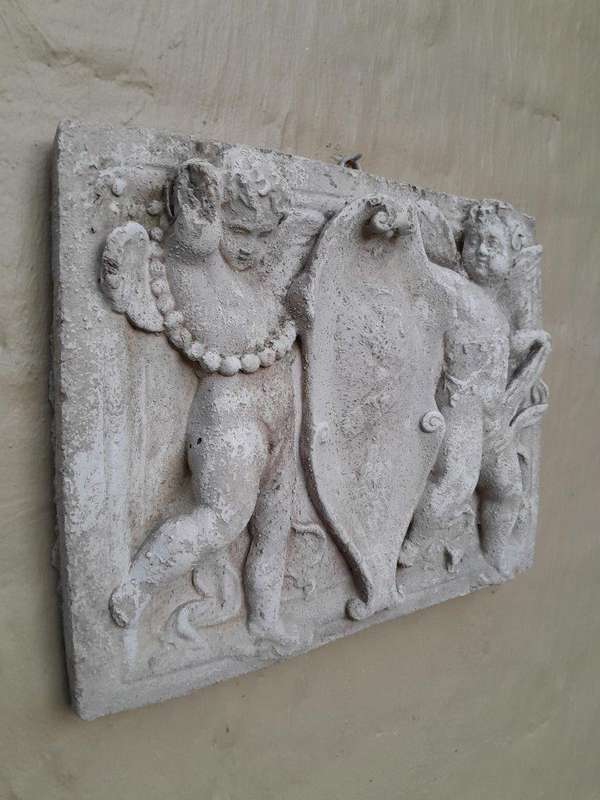A Concrete Relief Plaque Sculpture With Putti (Cherubs) Holding A Crest