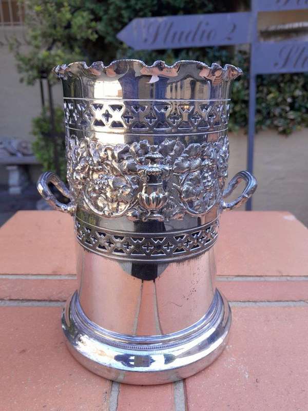 A Silver-Plate Wine Bottle Holder With Two Handles