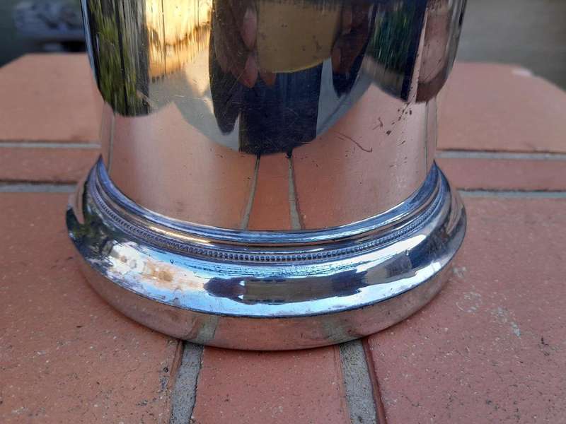 A Silver-Plate Wine Bottle Holder With Two Handles