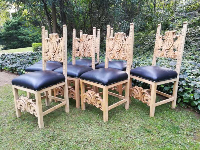 A 20th Century Set of Eight Carved and Bleached Oak Dining Chairs Upholstered in Leather