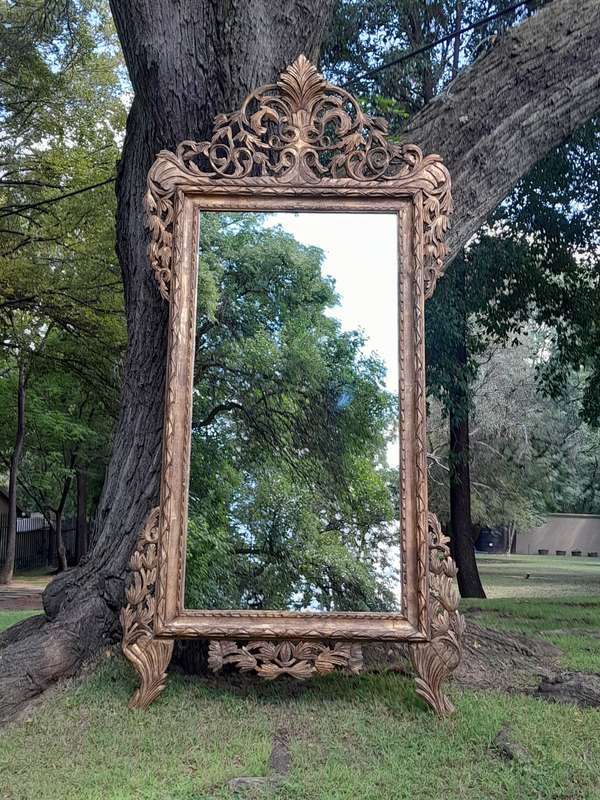 An Ornately Carved Wooden and Hand-Gilded Mirror of Large Proportion