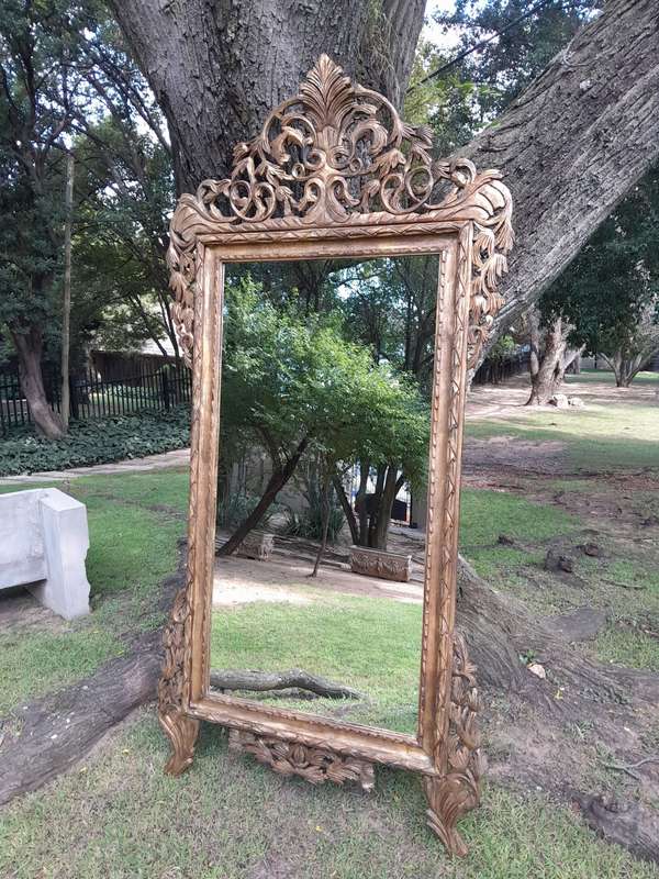An Ornately Carved Wooden and Hand-Gilded Mirror of Large Proportion