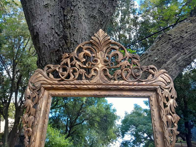 An Ornately Carved Wooden and Hand-Gilded Mirror of Large Proportion