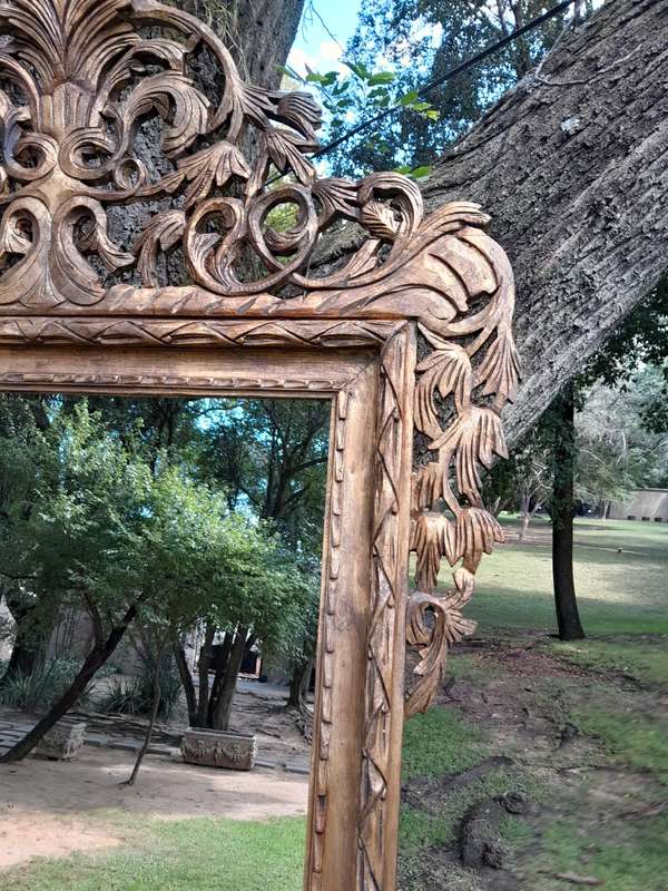 An Ornately Carved Wooden and Hand-Gilded Mirror of Large Proportion