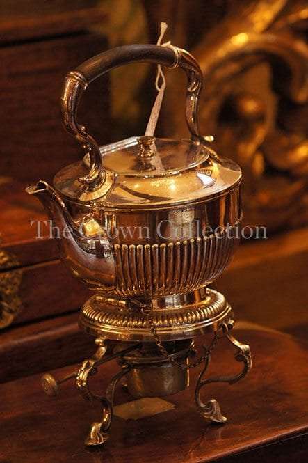Silver plated tea pot on burner