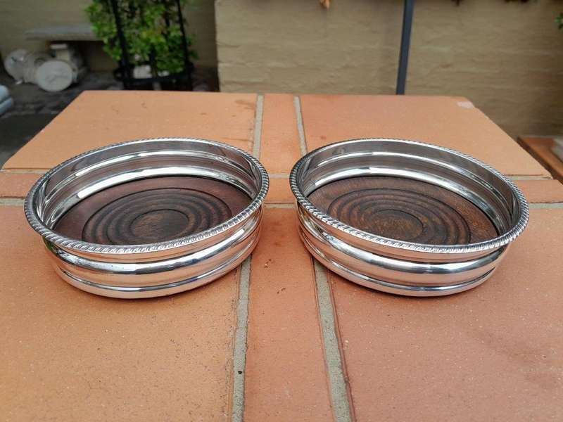 An Early 20th Century Pair of Silver plated Wine Bottle Coasters with Wooden Bases