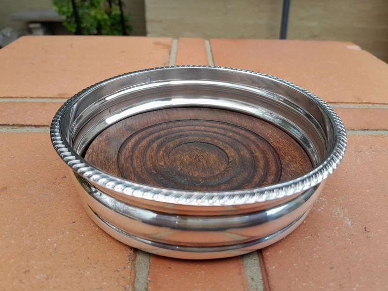 An Early 20th Century Pair of Silver plated Wine Bottle Coasters with Wooden Bases