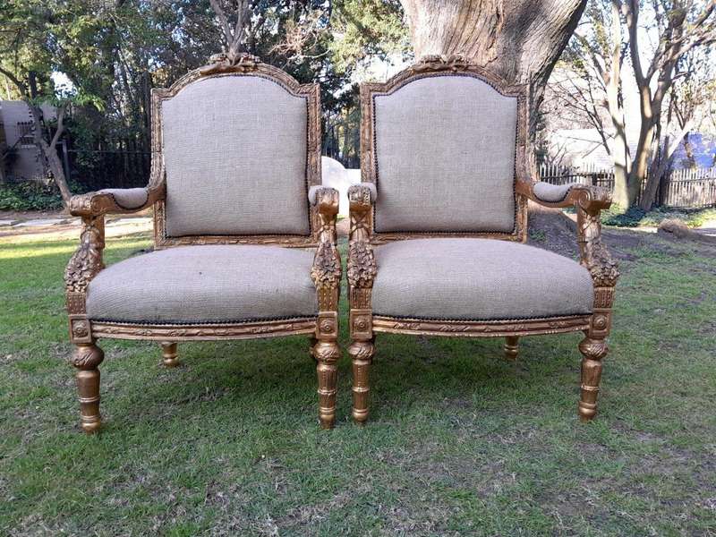 An Antique 19th Century French Pair of  Louis XV Style Heavily Carved Giltwood Armchairs