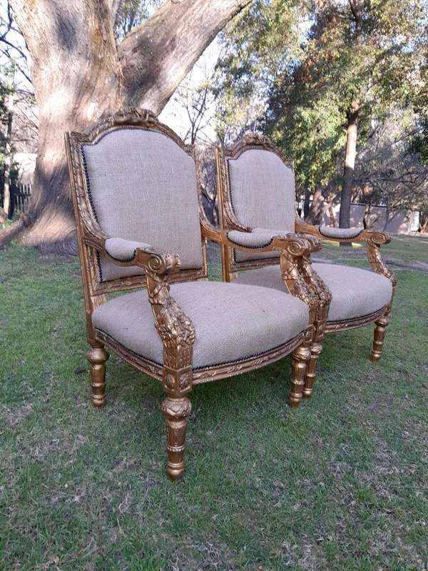 An Antique 19th Century French Pair of  Louis XV Style Heavily Carved Giltwood Armchairs