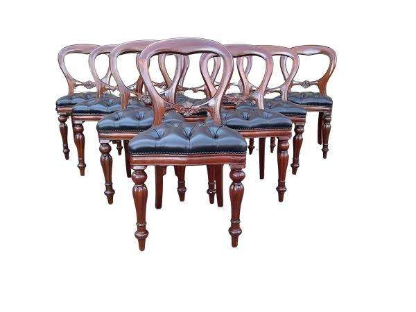 A 20th Century Set of Ten Teak Wood Bustle Back Chairs Upholstered in Deep Buttoned Leather