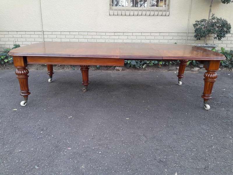 An Antique Victorian Oak Dining Table on Porcelain Castors with Two Leaves
