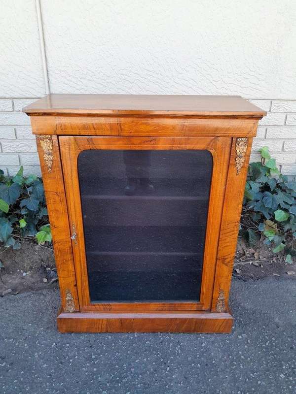 An Antique Victorian Walnut Cabinet with Metal Mounts and Glass Door