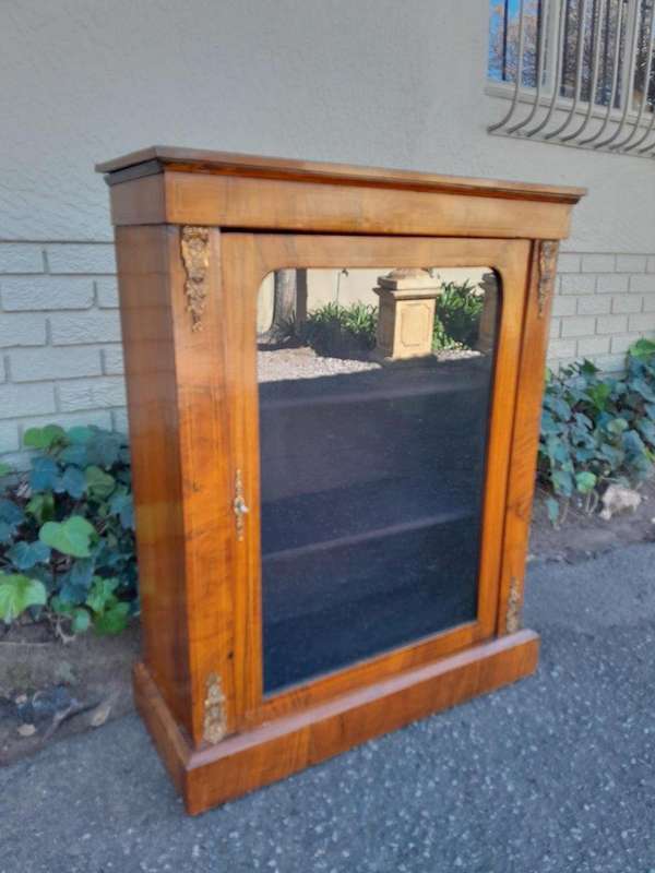 An Antique Victorian Walnut Cabinet with Metal Mounts and Glass Door