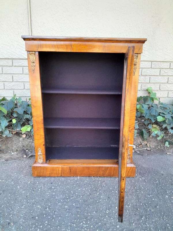 An Antique Victorian Walnut Cabinet with Metal Mounts and Glass Door
