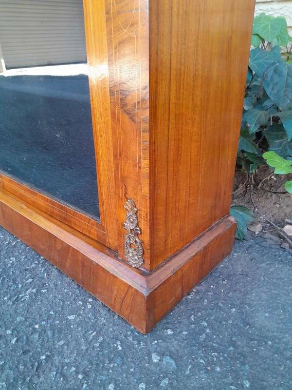An Antique Victorian Walnut Cabinet with Metal Mounts and Glass Door