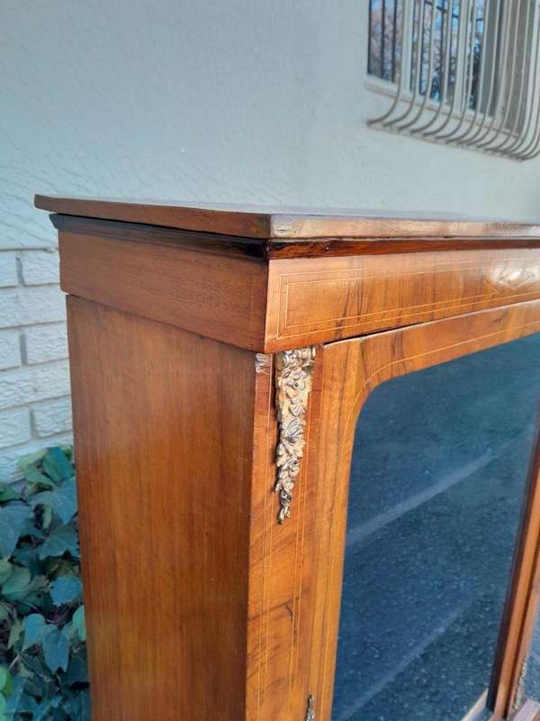 An Antique Victorian Walnut Cabinet with Metal Mounts and Glass Door