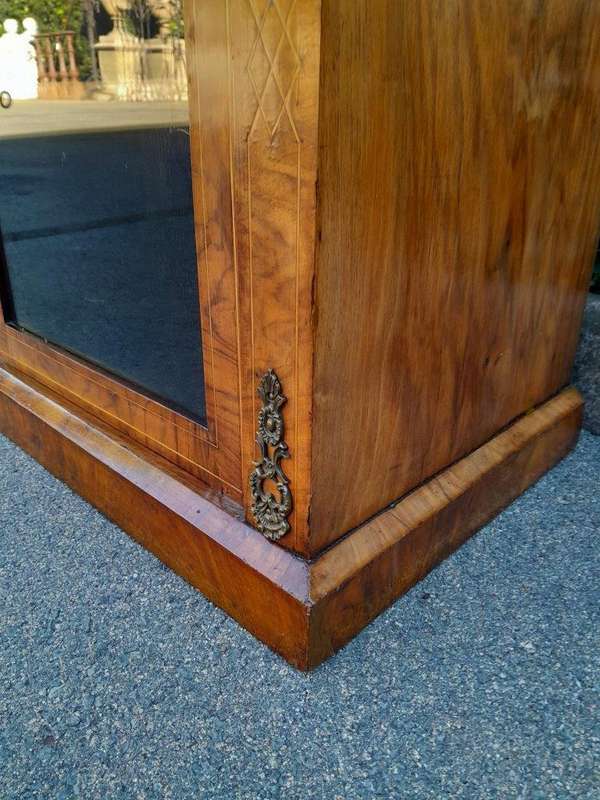 An Antique Victorian Walnut Cabinet with Metal Mounts and Glass Door